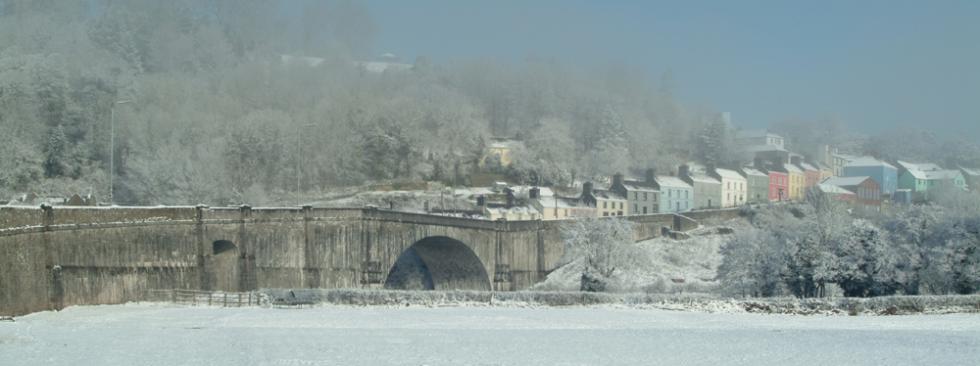 Llandeilo town and bridge emerging from mist after overnight snow